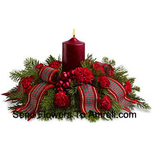 Celebrate a traditional family Christmas with this wonderful holiday centerpiece. Red carnations, Red Roses surround a red pillar candle, and a fancy ribbon adds a special touch! A lovely way to light the holiday table or a pretty sideboard decoration. (Please Note That We Reserve The Right To Substitute Any Product With A Suitable Product Of Equal Value In Case Of Non-Availability Of A Certain Product)
