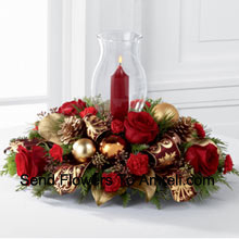 The Golden Christmas Centerpiece is the perfect display of holiday warmth and cheer to gather your friends and family together. Bright red roses and mini carnations are gorgeously arranged with holiday greens  And A Candle (Please Note That We Reserve The Right To Substitute Any Product With A Suitable Product Of Equal Value In Case Of Non-Availability Of A Certain Product)