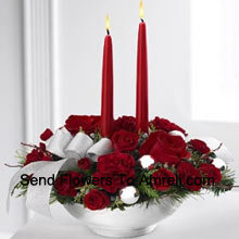 Our Holiday Elegance Centerpiece will add that special spark to their seasonal celebration with its vibrant array of crimson blooms! Red roses, carnations and sit amongst holiday greens in a Basket adorned with a beautiful silver ribbon accent and two taper candles to bring a holiday glow of warmth and peace to their table. (Please Note That We Reserve The Right To Substitute Any Product With A Suitable Product Of Equal Value In Case Of Non-Availability Of A Certain Product)