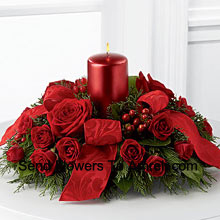 A crimson display of holiday warmth and cheer. Rich red roses and Red Carnations With A Candle  to create a heart-warming centerpiece. Bedecked with bright red ribbon, this design will bring the spirit of the holiday season to their gatherings and celebrations with style and grace. (Please Note That We Reserve The Right To Substitute Any Product With A Suitable Product Of Equal Value In Case Of Non-Availability Of A Certain Product)